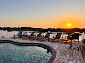 Gorgeous vacation home on the water with heated pool and sand!